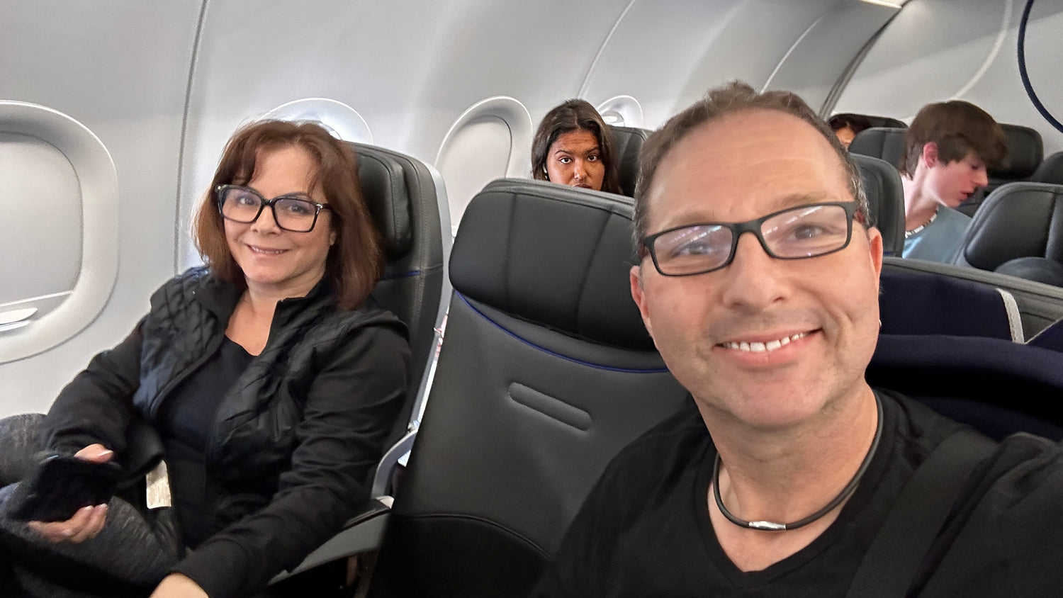 Guy Bavli and his wife relaxing on a plane with the Mat-Trix Travel Mat.